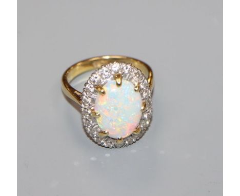 An 18ct, white opal and diamond oval cluster ring, size O.