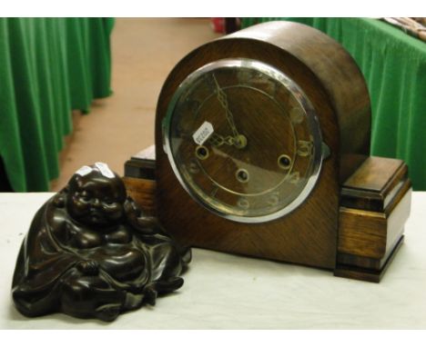 A composition Buddha figure and an oak 3-train mantel clock.