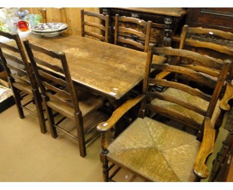 A rectangular oak refectory dining table, length 5' together with a set of 6 oak ladder back rush seated dining chairs.