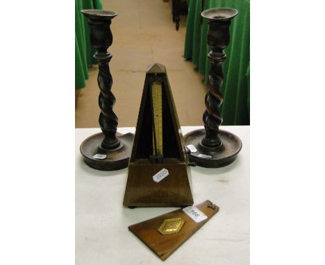 A French mahogany cased metronome and a pair of barleytwist candlesticks.