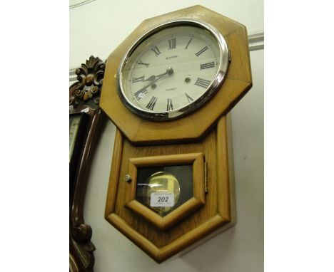 A light oak drop dial wall clock.