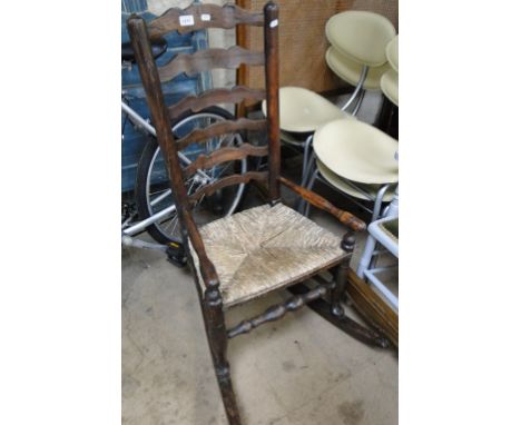 An 18th century oak ladder back rocking chair