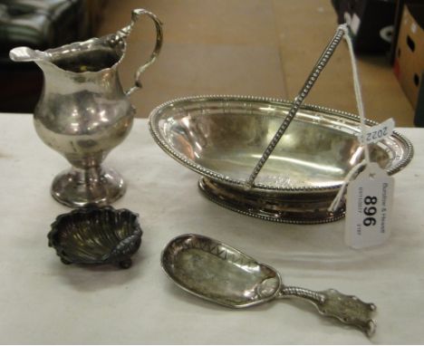 Small Victorian silver swing handled basket, 4oz, small silver salt, continental silver caddy spoon and a small cream jug