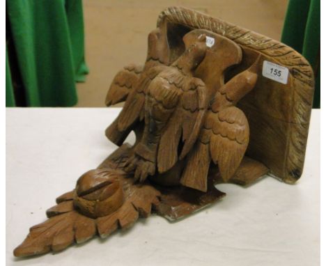 A Black Forest carved shelf bracket supported by 3 birds.