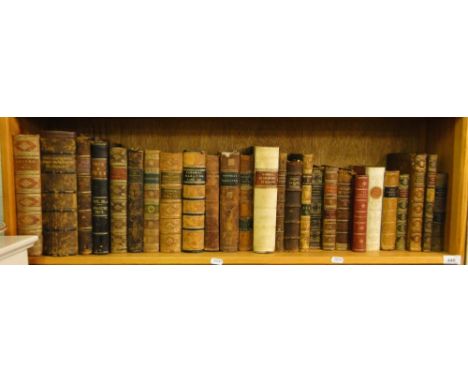 A shelf of various 19th century leatherbound books including Dickens & bound magazines