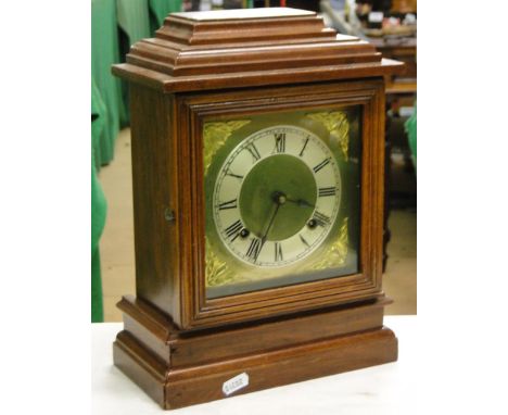A 2-train mantel clock with brass dial.