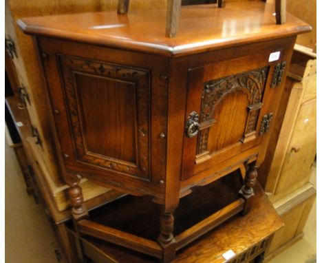 A carved oak canted corner console table.