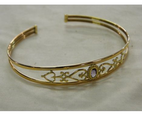 A 9ct gold and amethyst set bangle, 4.8g
