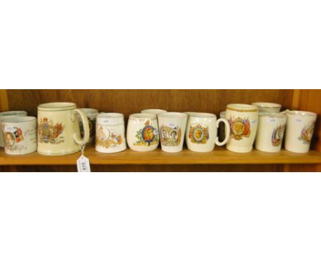 A shelf of Royal Commemorative mugs and beakers including 1953, and Victoria's Diamond Jubilee.