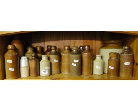 A shelf of Stoneware jars and bottles.