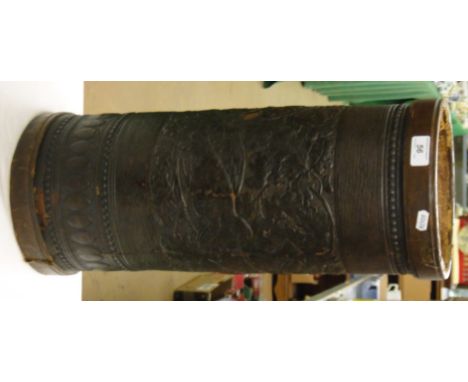 A leather covered stick stand with animal and foliage decoration.