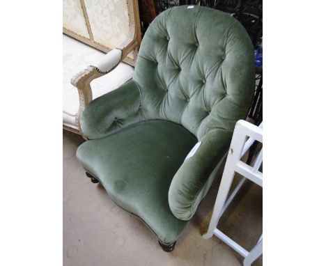 An Edwardian button back armchair