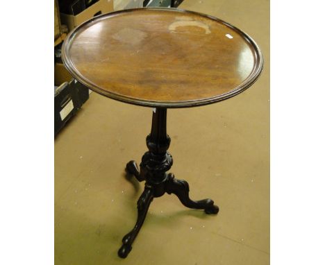 A 19th century mahogany tripod table on carved base.