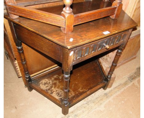 A carved oak canted corner console table.