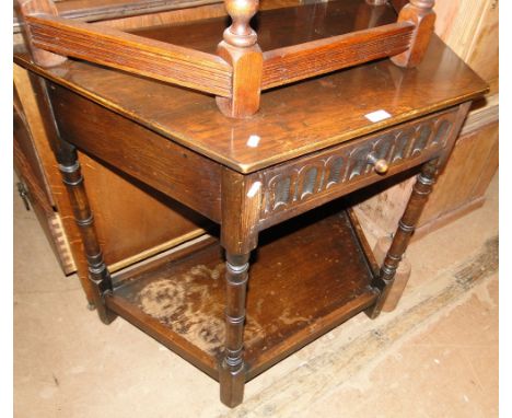 A carved oak canted corner console table.