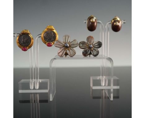 This lot includes three distinct pairs of vintage-style clip-on earrings. The first pair is crafted from a smooth, dark brown