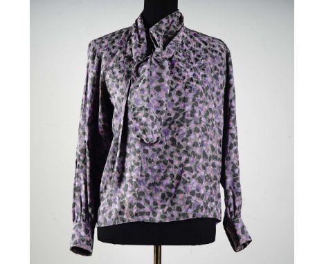 Embrace vintage Parisian elegance with this stunning Saint Laurent Rive Gauche blouse. Crafted in France from lightweight sil