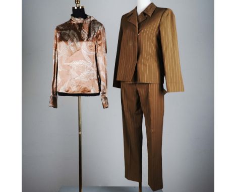 This ensemble from Valentino Roma exemplifies understated luxury with a timeless silhouette and refined materials. The tailor