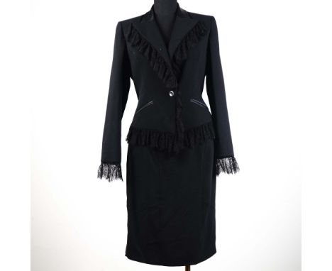 Striking and refined, this vintage Valentino black wool skirt suit offers an exceptional blend of classic tailoring and roman
