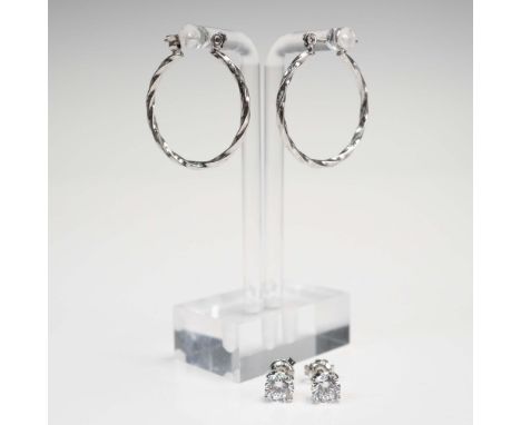 Polished 2-piece earring lot featuring one pair of classic silver-tone hoop earrings and one pair of solitaire-style stud ear