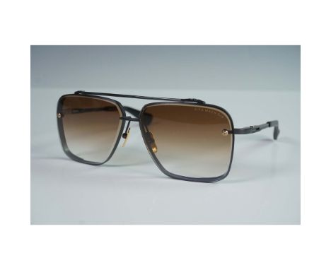 These high performance Dita Mach Six sunglasses showcase a bold square silhouette with black titanium frames, gold-tone detai