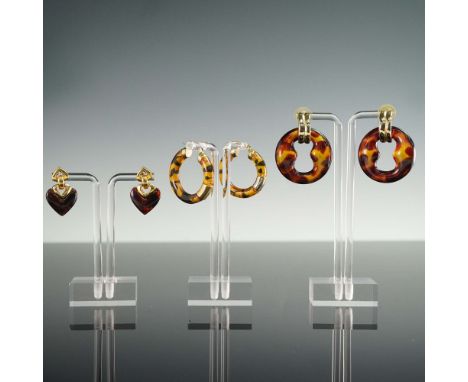 Lot of three pairs of vintage earrings featuring warm brown tones and bold sculptural designs. Includes a pair of amber-hued 