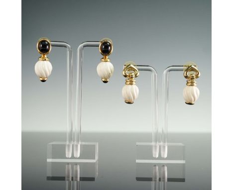 Pair of vintage gold-tone drop earrings featuring cream-colored swirl beads and black cabochon accents. One pair is designed 