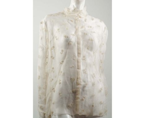 Delicate Valentino ivory sheer silk blouse featuring tonal floral embroidery throughout. The blouse is constructed in a light
