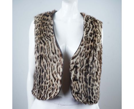 Striking sleeveless vest made from exotic fur, featuring a classic leopard print pattern. The piece is designed with a V-neck