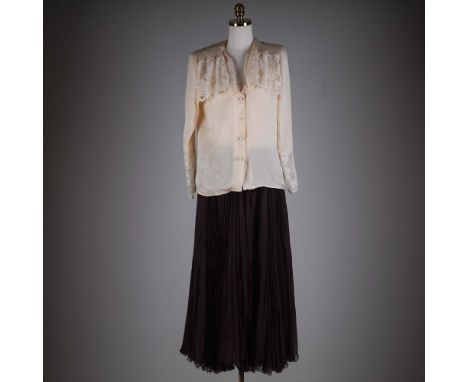 This vintage Valentino Night ensemble exudes timeless sophistication, featuring a soft ivory silk blouse adorned with cascadi