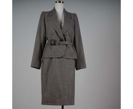 This sophisticated two-piece wool skirt suit by Yves Saint Laurent Rive Gauche features a classic houndstooth pattern in mute