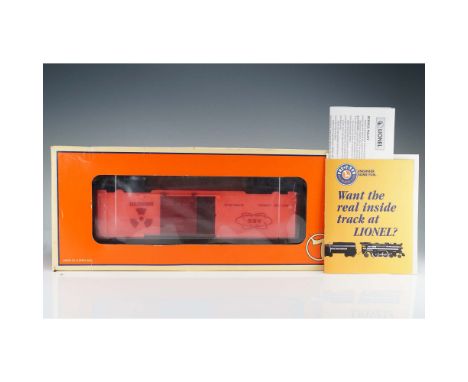 Lionel model 9700-GLO boxcar featuring vivid red-orange body with glow-in-the-dark finish, prominently marked AEC (Atomic Ene