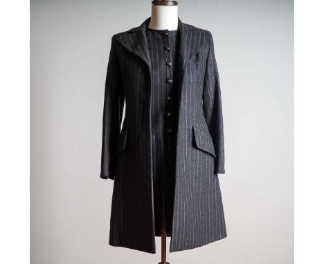 This sophisticated ensemble from Valentino Boutique features a tailored sleeveless dress and coordinating long coat in a clas