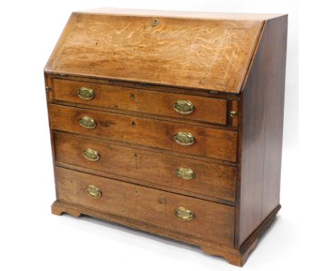 A George III oak bureau, the fall enclosing a vacant interior above four graduated drawers, each with oval brass handles, on 
