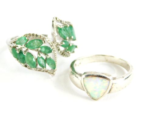 Two silver dress rings, to include one set with opal, the other two fern design set with green stones.