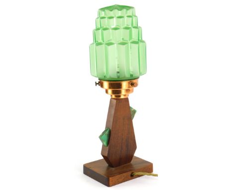 An Art Deco lamp base, the green moulded shade of tapering form with a copper fitting, the mahogany base applied with green m