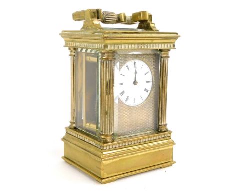A late 19th/early 20thC French miniature carriage clock, with engine turned decoration, surrounding the enamel dial with Roma