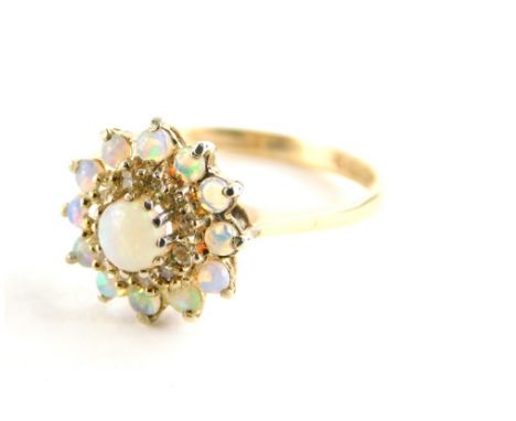 A 9ct gold opal and diamond dress ring, with central opal surrounded by a halo of diamonds and a further surround of opals, e