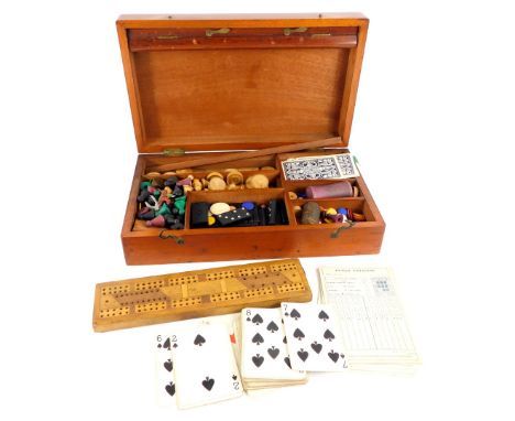 A late 19th/ early 20thC mahogany games box or compendium, to include draughts, cribbage, dominoes, etc.