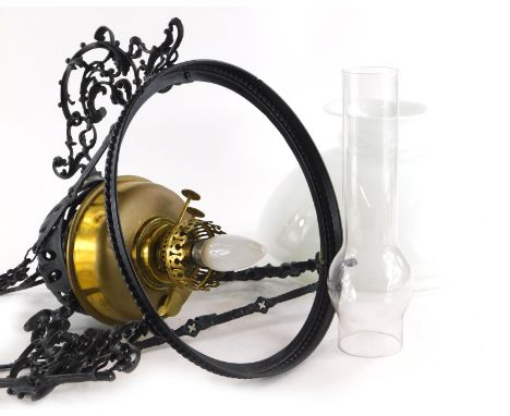 A Victorian brass and cast metal hanging oil lamp, with opaque shade, converted to electricity.
