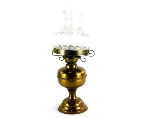A 20thC brass oil lamp, with clear shade, on domed foot, 52cm high.
