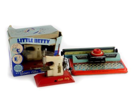 A Mettoy tin plate child's typewriter, a Little Betty child's sewing machine and another. (boxed)