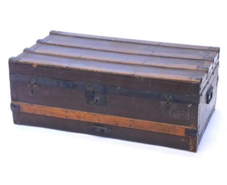 A canvas and wooden bound trunk, with metal brackets and side handles, 79cm wide.