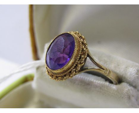 9ct YELLOW GOLD AMETHYST SET SOLITAIRE RING, oval cut amethyst of good colour in fancy split shank setting, size L/M 