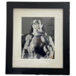 A framed black and white photograph bearing the signature of American actor and bodybuilder, Lou