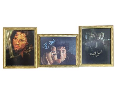 Three Lord of the Rings colour photographs, bearing the signatures of Viggo Mortensen (Aragorn); Billy Boyd (Pippin) and Elij