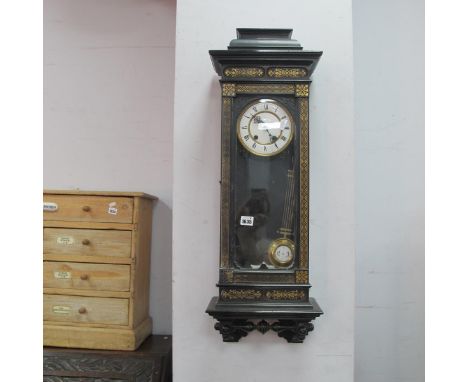 A Late XIX Century Ebonised Vienna Style Wall Clock, the case with gilt geometric and foliate designs, the white enamel dial 
