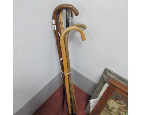 A Late XIX Century Ebonised Walking Stick, with a silver handle and other walking sticks. (6).