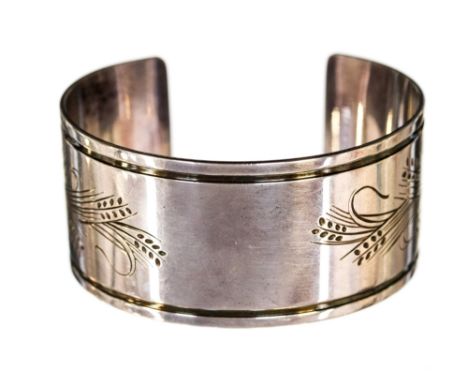 Georg Jensen, a Danish silver bangle or cuff, engraved with a stylised wheat design, pattern 85 B, marks and import marks for