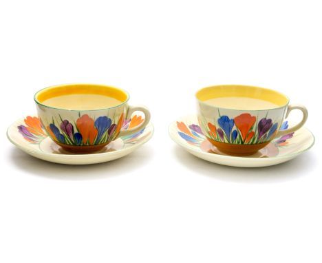 Clarice Cliff for Wilkinson and Newport Pottery, two Crocus pattern tea cups and saucers, Bizarre marks, one cup marked for N